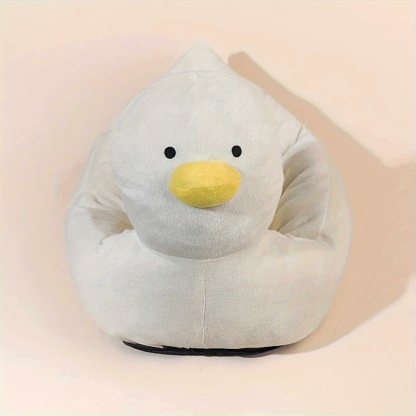 Blue duck-shaped fluffy pet bed sofa for small dogs and cats on a floor.