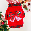 Red Christmas jumper for a small dog on a festive background