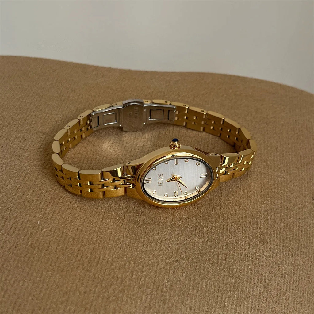 Oval dial ladies watch with dot markers, 37mm, gold strap and gold face