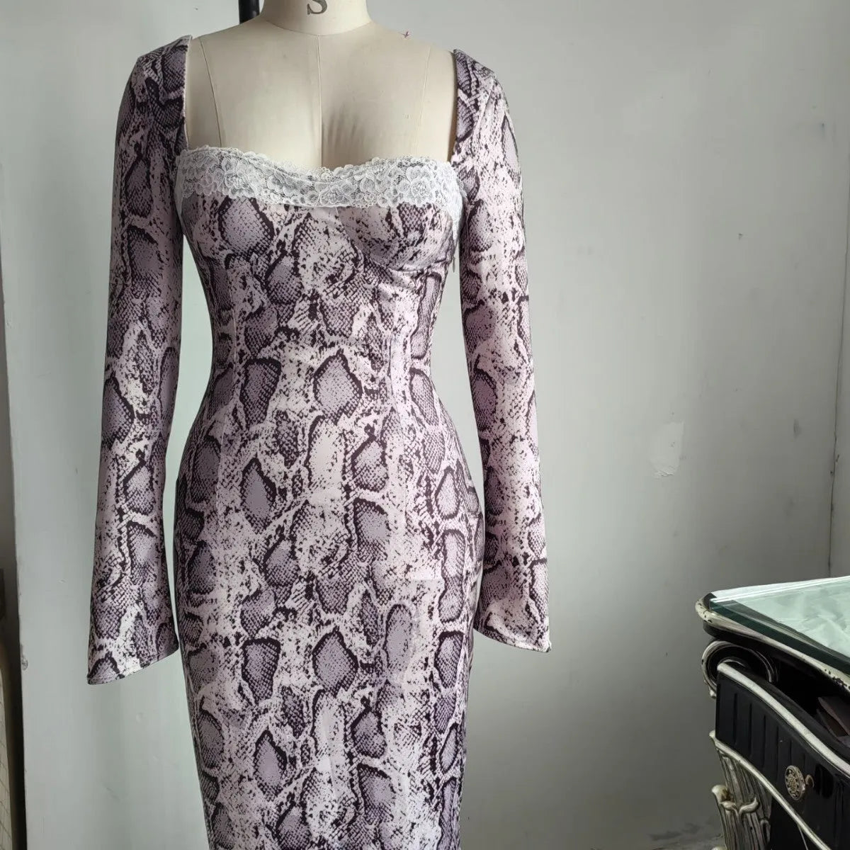 Grey slim fit lace dress with 3D digital print pattern and long sleeves on mannequin