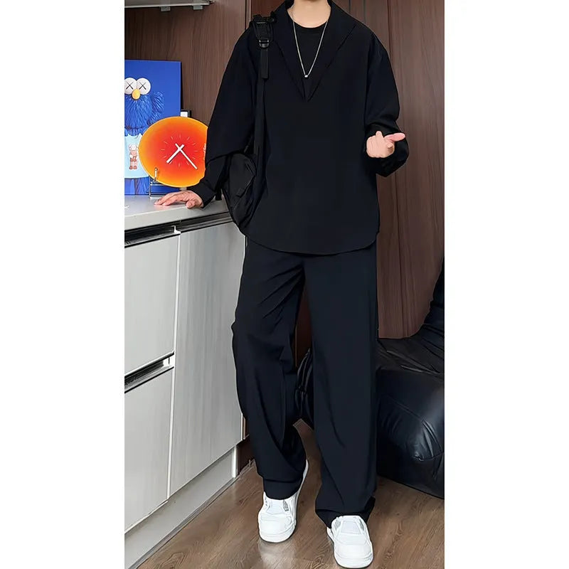 Man wearing a black slim fit long sleeve polo shirt and matching trousers from a casual two-piece set.