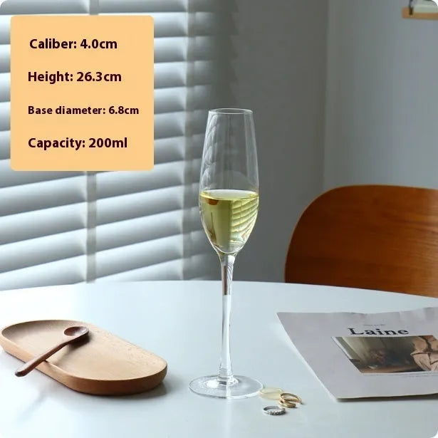 Six French crystal champagne glasses in various designs on dining table