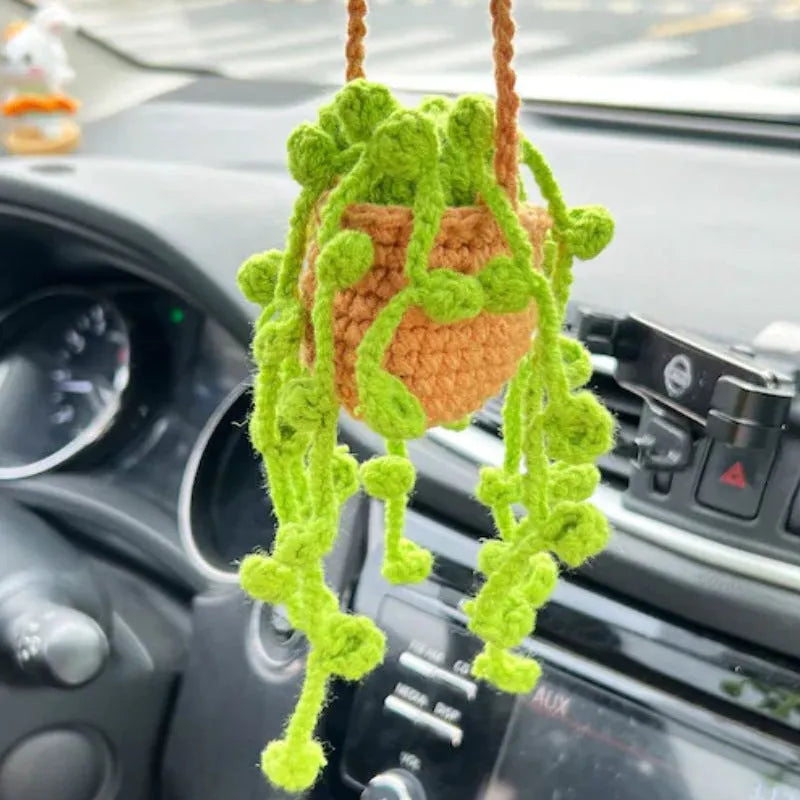Green and white fish-scale style knitted wool car hanging planter with 8cm base and long white cord.
