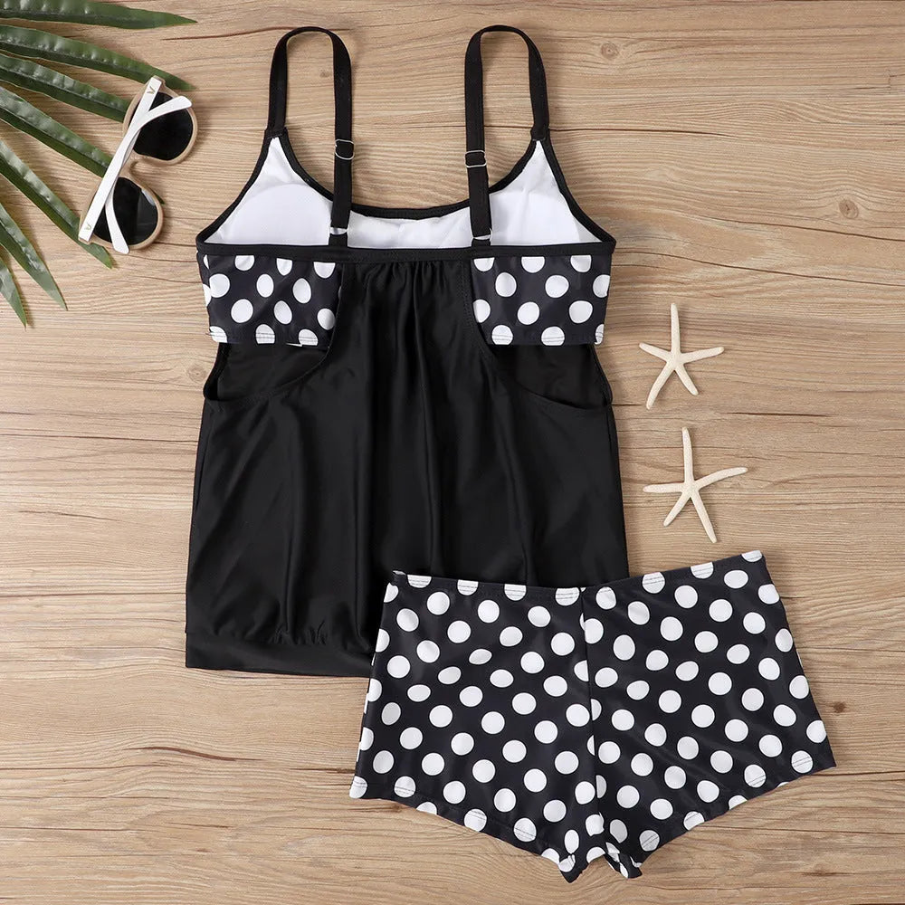 Women's black polka dot high-waist swimsuit briefs and top on a mannequin