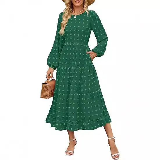 A woman wearing a beige high waist long sleeve dress with ruffled sleeves, a round neck, and a solid colour design.