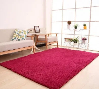 Solid colour fluffy plush carpet with non-slip dots on bottom, shown in beige on a wooden floor.