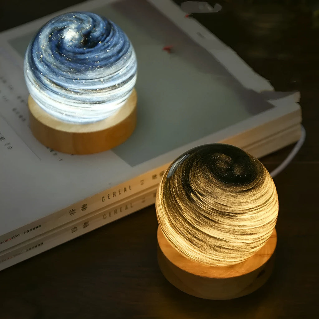 Modern planet-shaped USB night light on its base with dimmable multi-colour glow