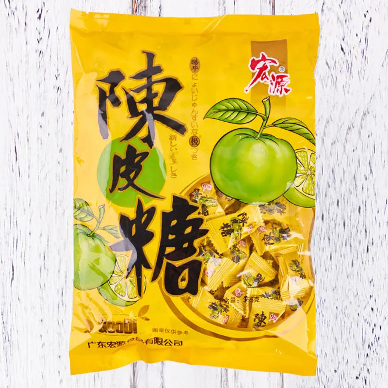 Three bags of Asian fruit hard candy: plum sugar, guava, and tangerine peel varieties with weight labels