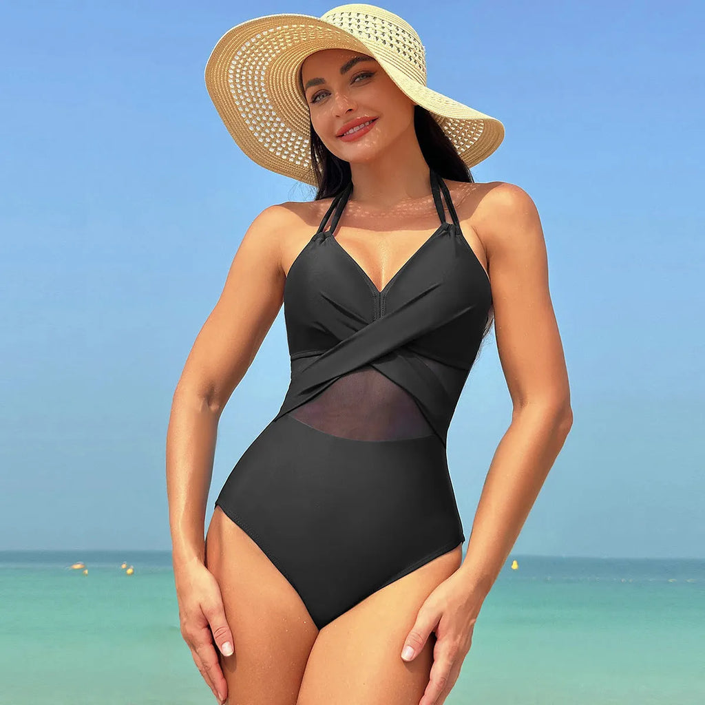 Halter-neck one-piece swimsuit with cross-strap back and mesh detail in solid colour