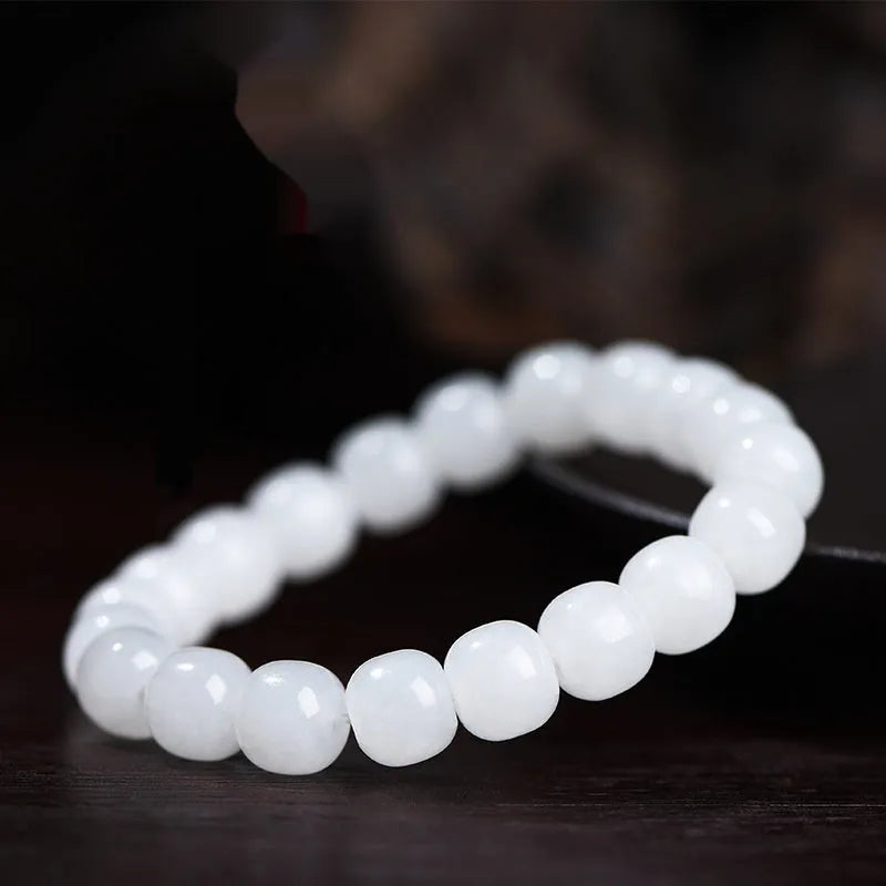 White Hetian jade barrel bead bracelet showing smooth polished beads on wrist
