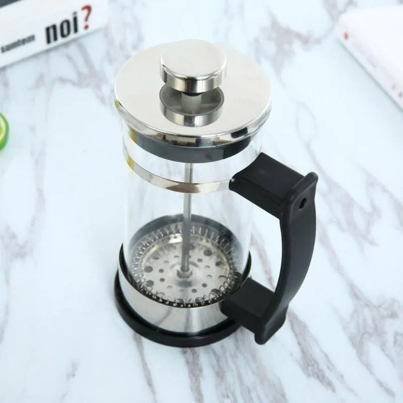Small glass French press coffee maker with stainless steel plunger, shown with dimensions 10cm by 8cm by 17cm.