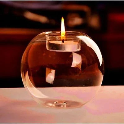 Handmade round hollow glass candle holder in clear glass on wooden surface