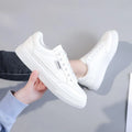 Women's low-top Korean style sneakers in white or brown artificial PU with a solid colour design.