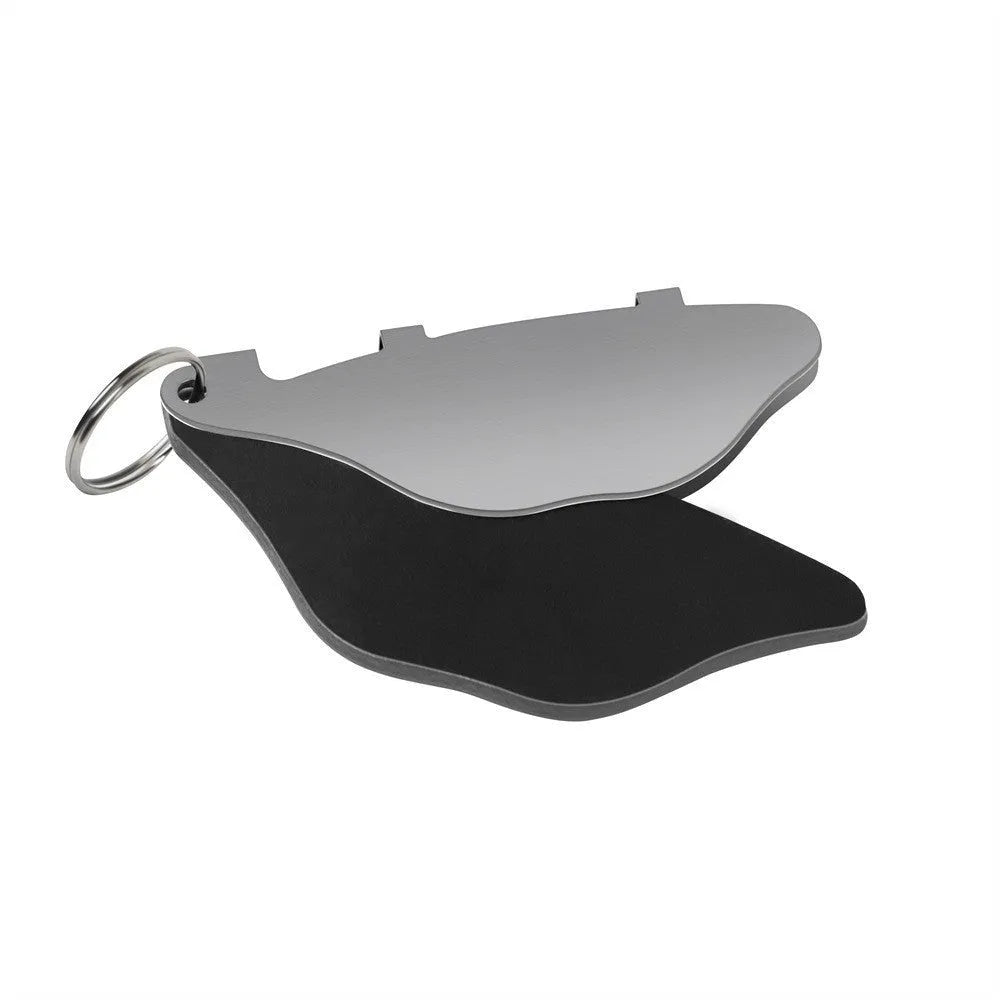 Black and orange metal mountain bike disc brake pads with an adjustment flap.