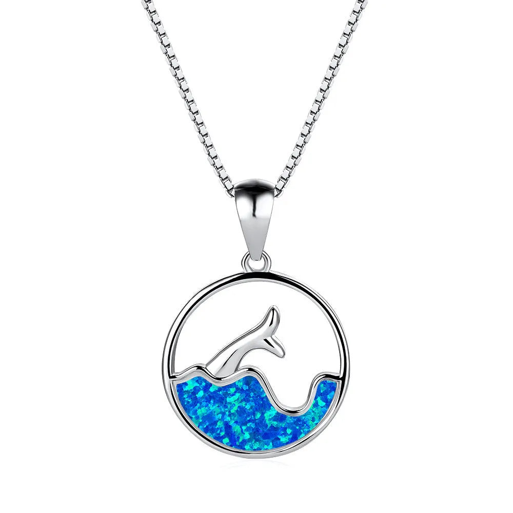 White gold electroplated copper necklace with a geometric sea fishtail pendant in a blue opal tone.