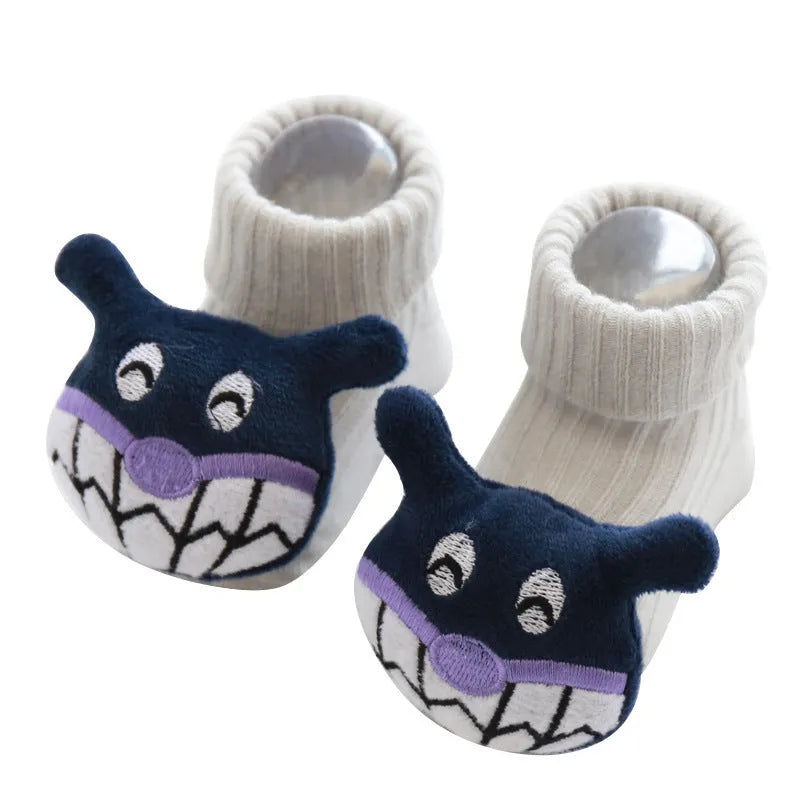 Cotton baby floor socks with non-slip soles in a pink bow print design.