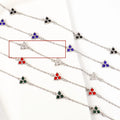 Geometric stainless steel women's bracelet with triangular links and a coloured stone centre.