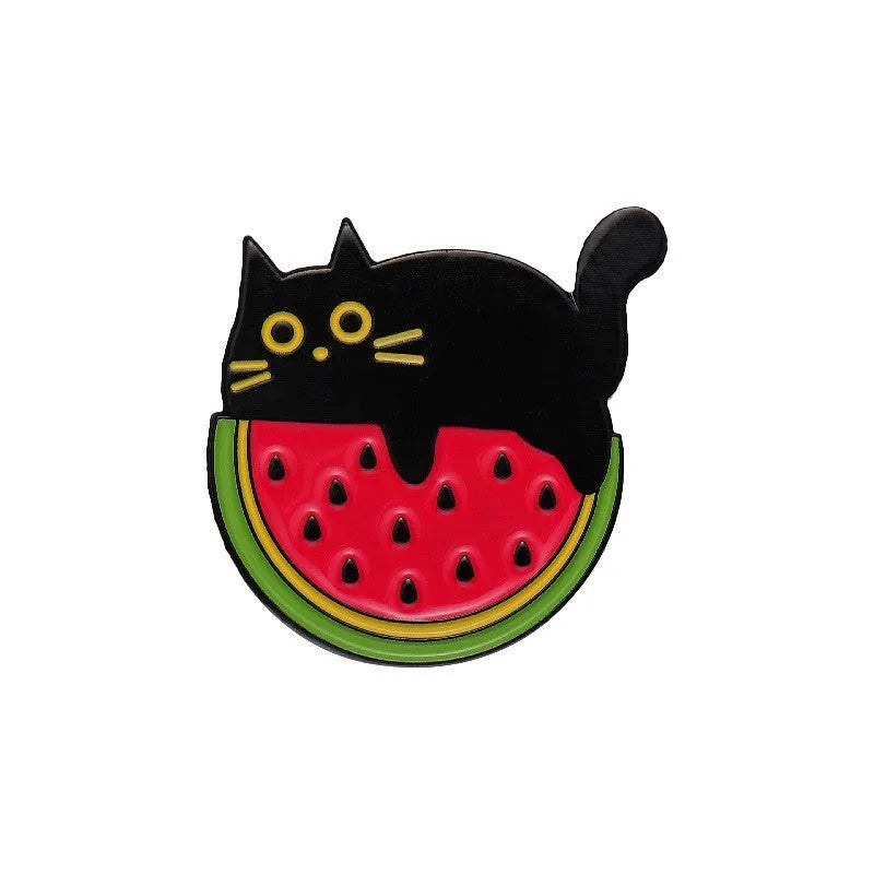 Colourful cartoon fruit design zinc alloy brooch pin on a fabric background.