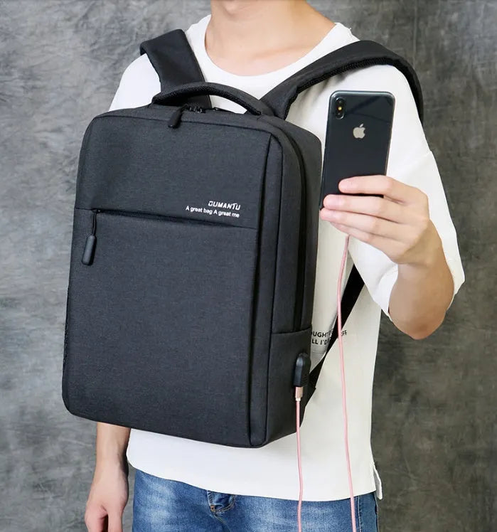 Waterproof rechargeable laptop backpack in multiple colours, shown with a 15.6 inch laptop in its padded compartment.