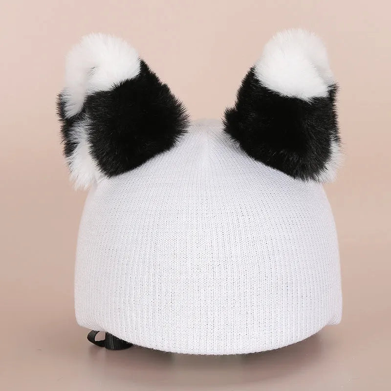Colourful plush cartoon hat decoration sitting on top of a ski helmet
