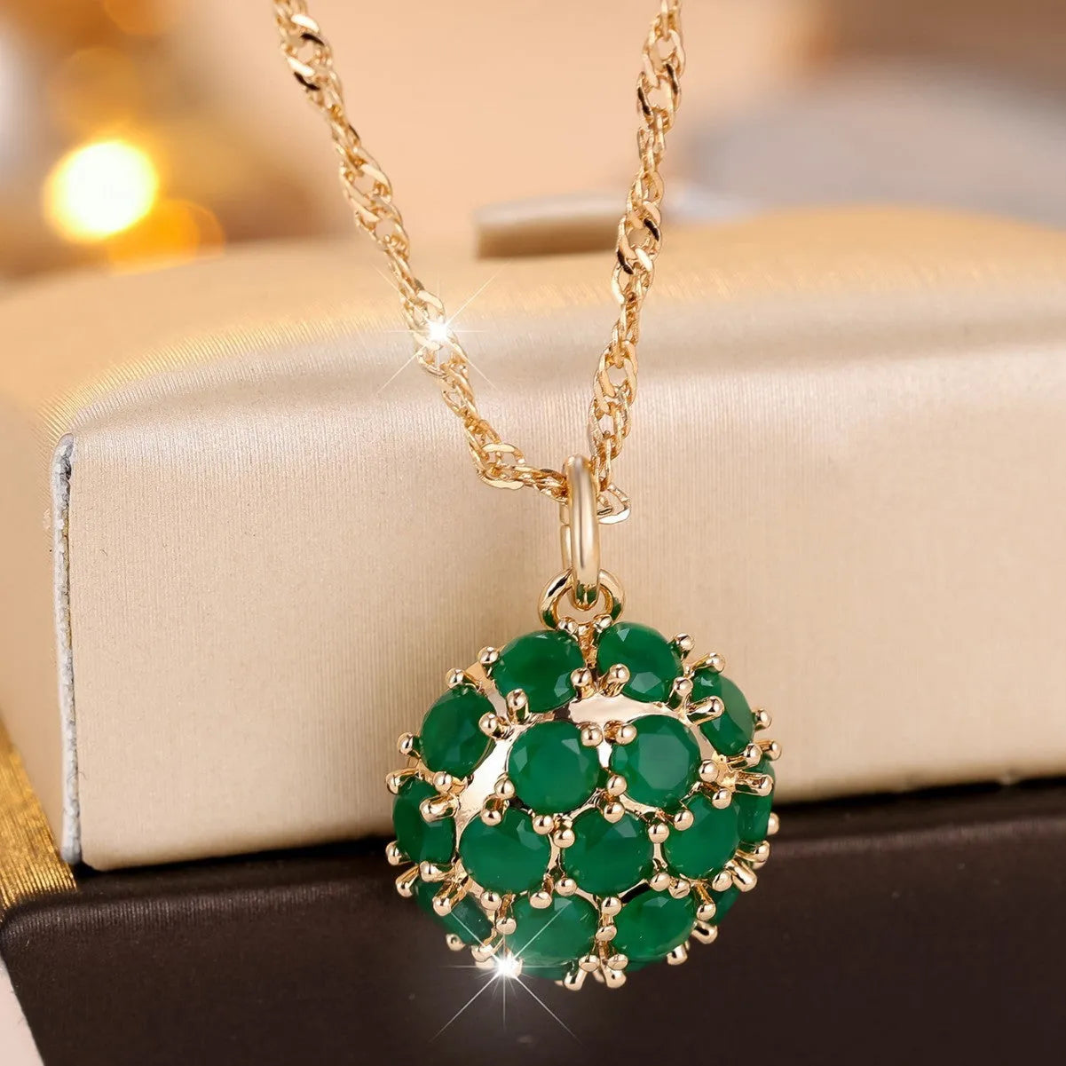 Champagne gold round emerald and diamond pendant necklace on a copper chain