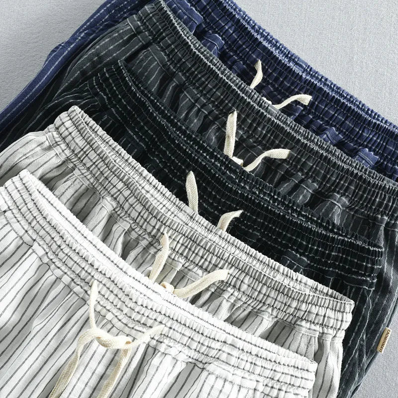 Men's striped casual shorts with elastic waistband in turmeric colour showing loose straight cut