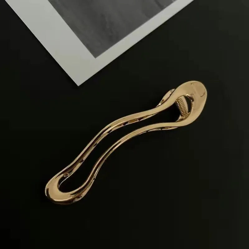 Women's geometric hair clips in polished zinc alloy, gold and silver colours, square arc triangle shapes