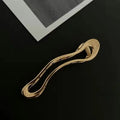 Women's geometric hair clips in polished zinc alloy, gold and silver colours, square arc triangle shapes