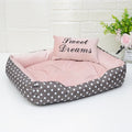 Small polka dot print square dog bed with a matching square pillow inside, shown in grey colour.