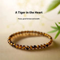 Geometric new Chinese style bracelet with round tigereye stone beads in gold and brown bands.