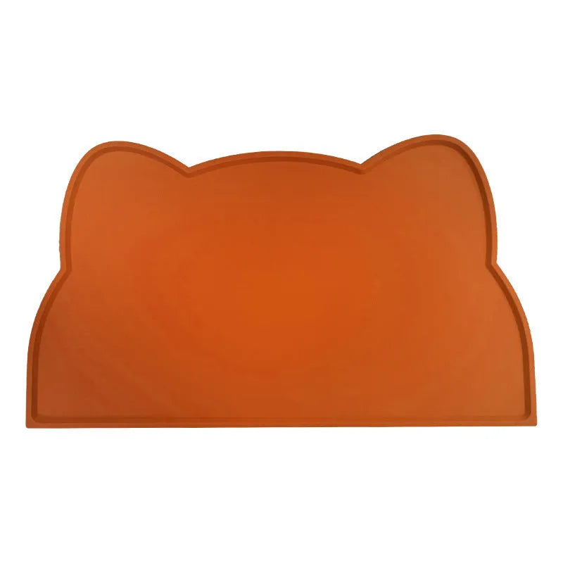 Blue silicone pet feeding mat for dog or cat bowls on a wooden floor.