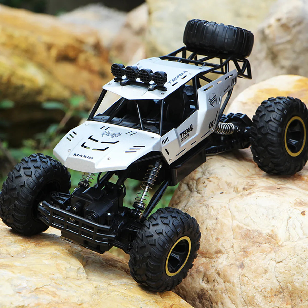 Black and silver 4WD remote control off-road climbing cars on rough terrain showing two size options.
