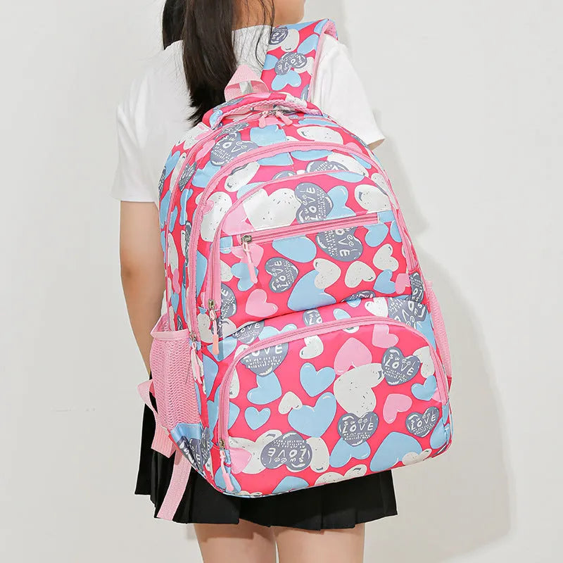Blue children's school backpack with air pillow straps on a grey background.