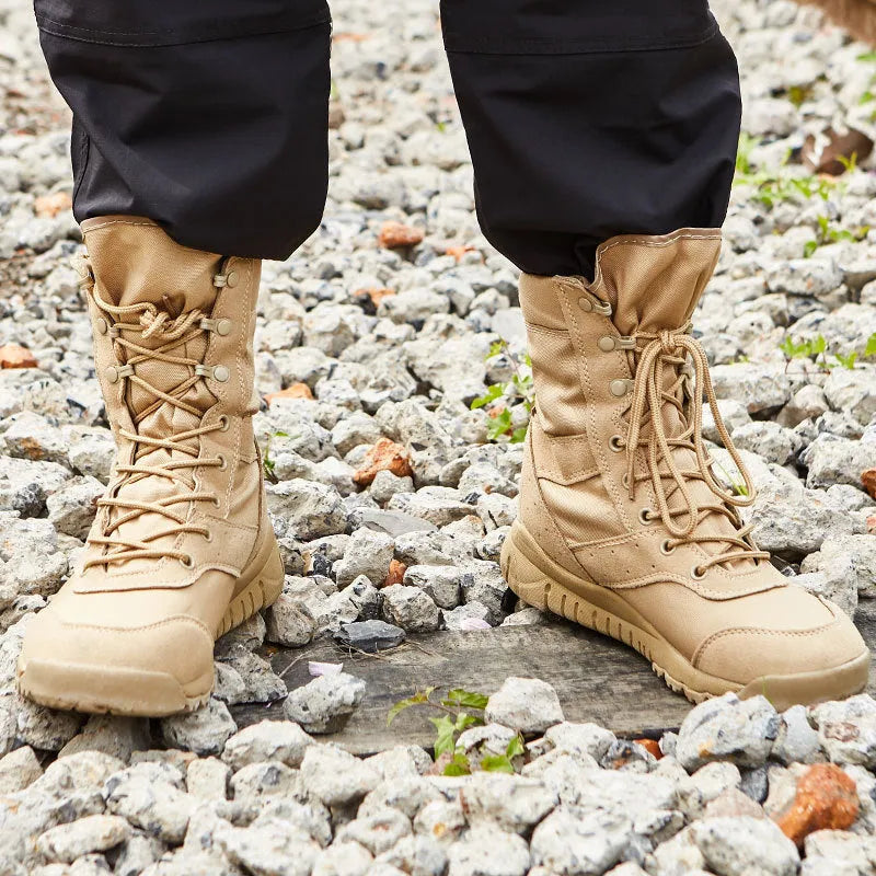 Yulong combat tactical desert boots in black and sand colour on a rocky outdoor background.