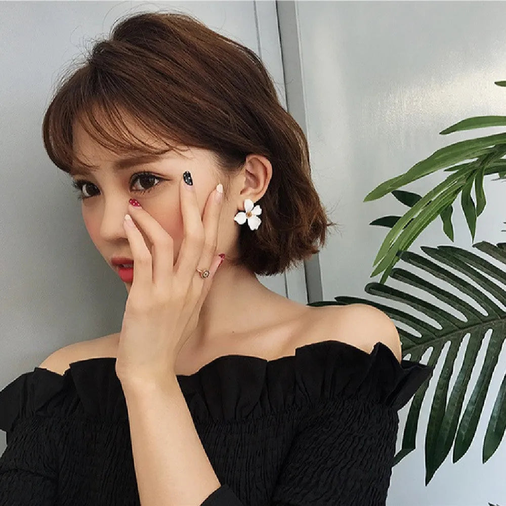 Flower shaped stud earrings in pink or white colour with electroplated alloy construction