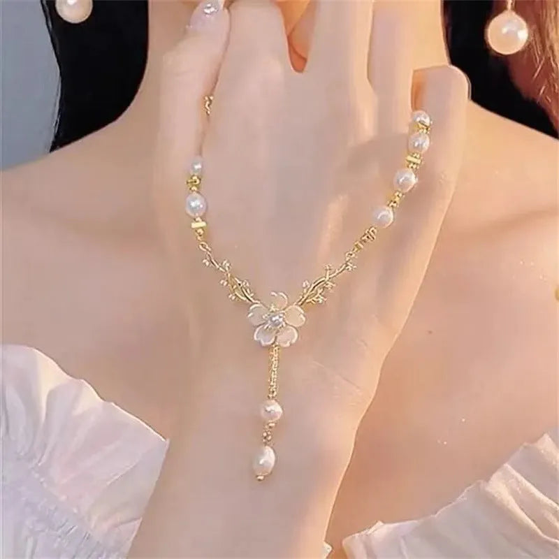 Pearl white alloy necklace with flower pearl charm and rose floral design elements on pearl chain