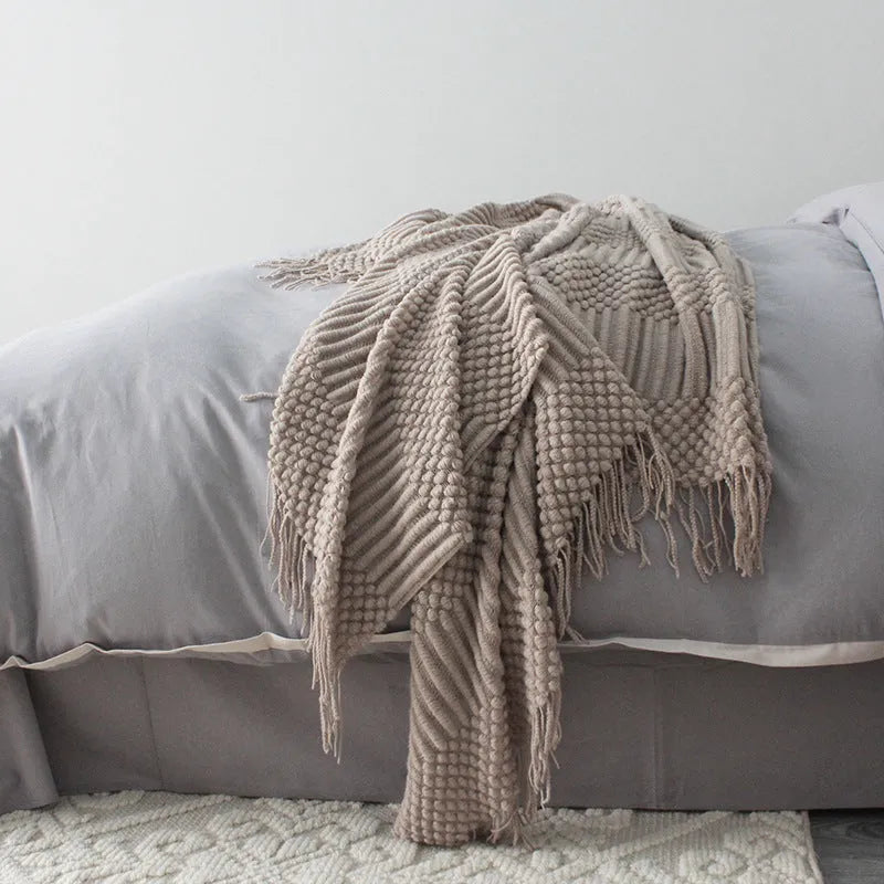 Small grey polyester nap blanket laid flat showing its size.