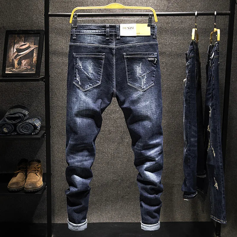 Men's slim-fit skinny jeans in dark blue cotton denim fabric on a hanger.