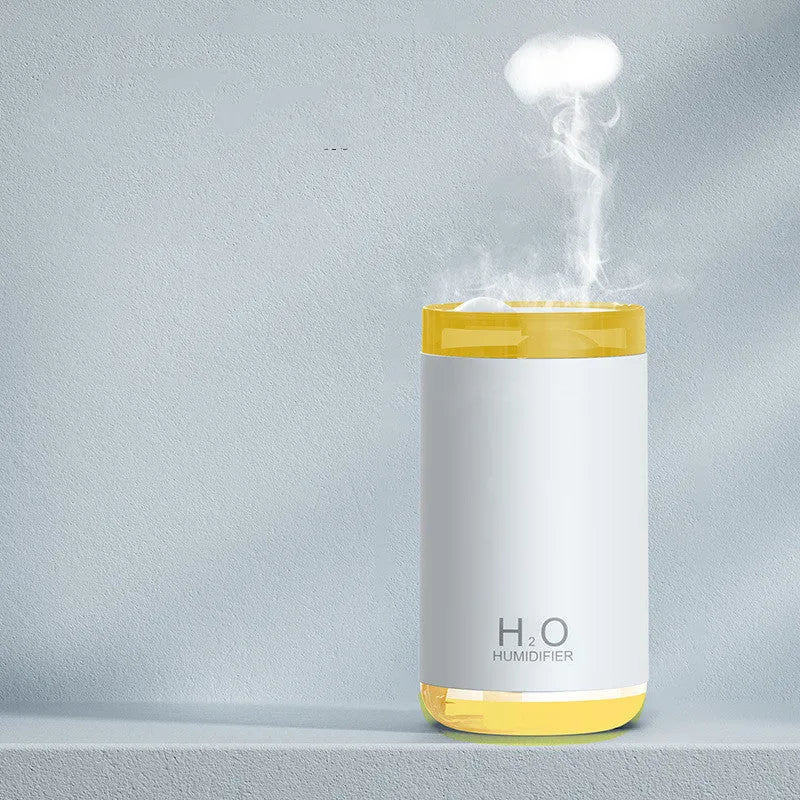 Jellyfish-shaped humidifier producing smoke ring mist with warm night light illumination