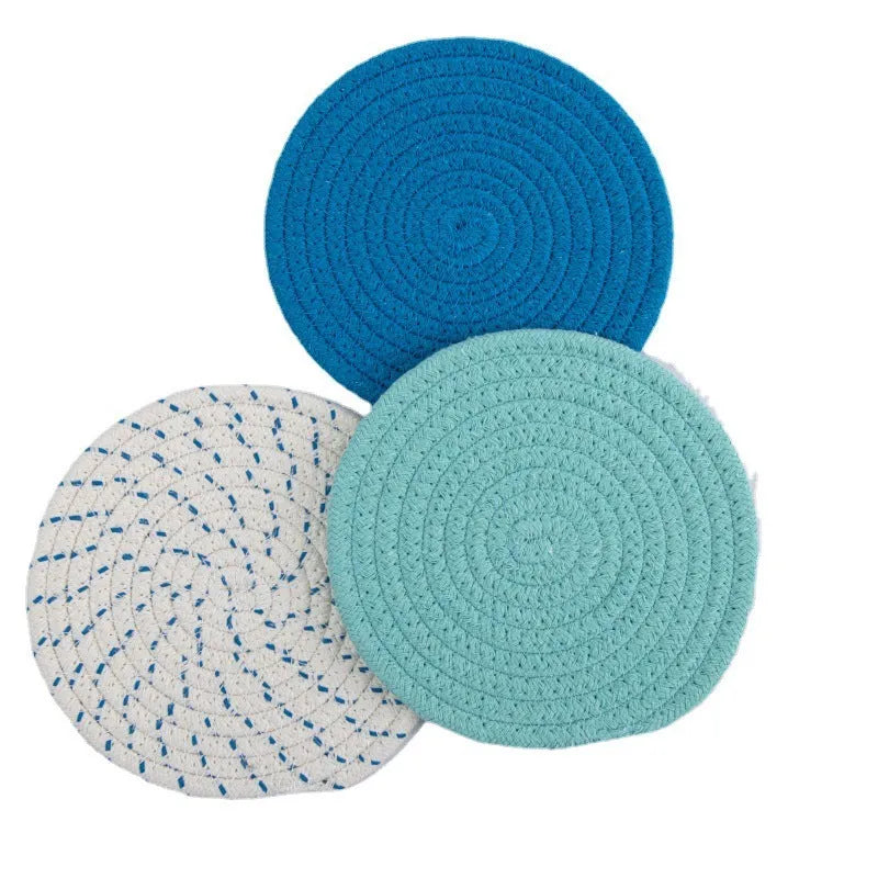 Set of three round cotton cord coasters in a choice of colours on a wooden table
