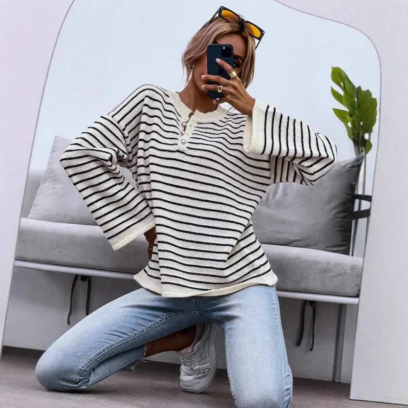 Black and white striped women's loose top with drop-shoulder sleeves and button detail