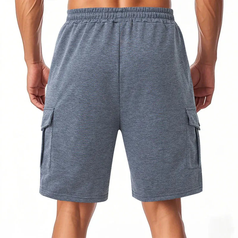 Men's loose grey terry fabric cargo shorts with multiple pockets on a hanger.