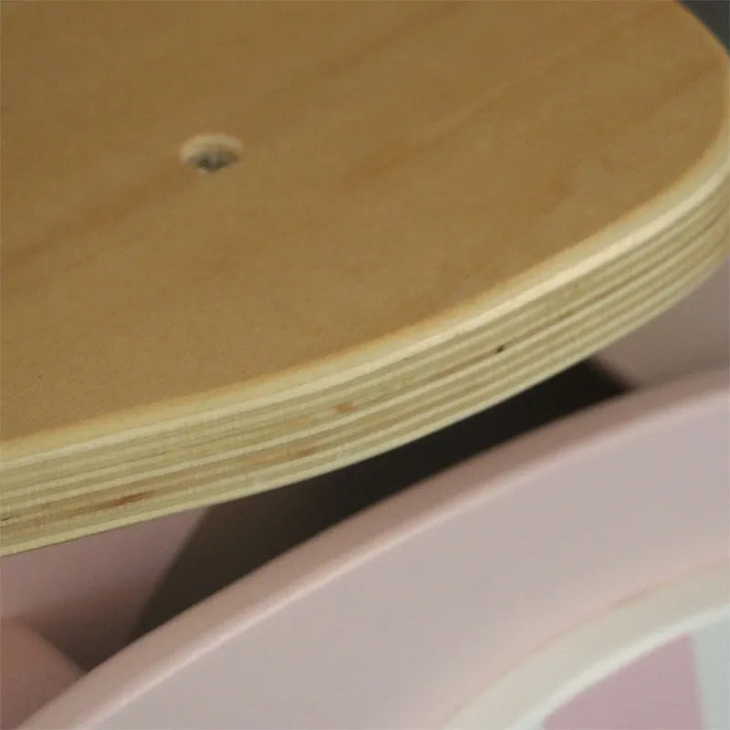 Pink wooden balance scooter for toddlers and young children on a 10-inch wooden deck.
