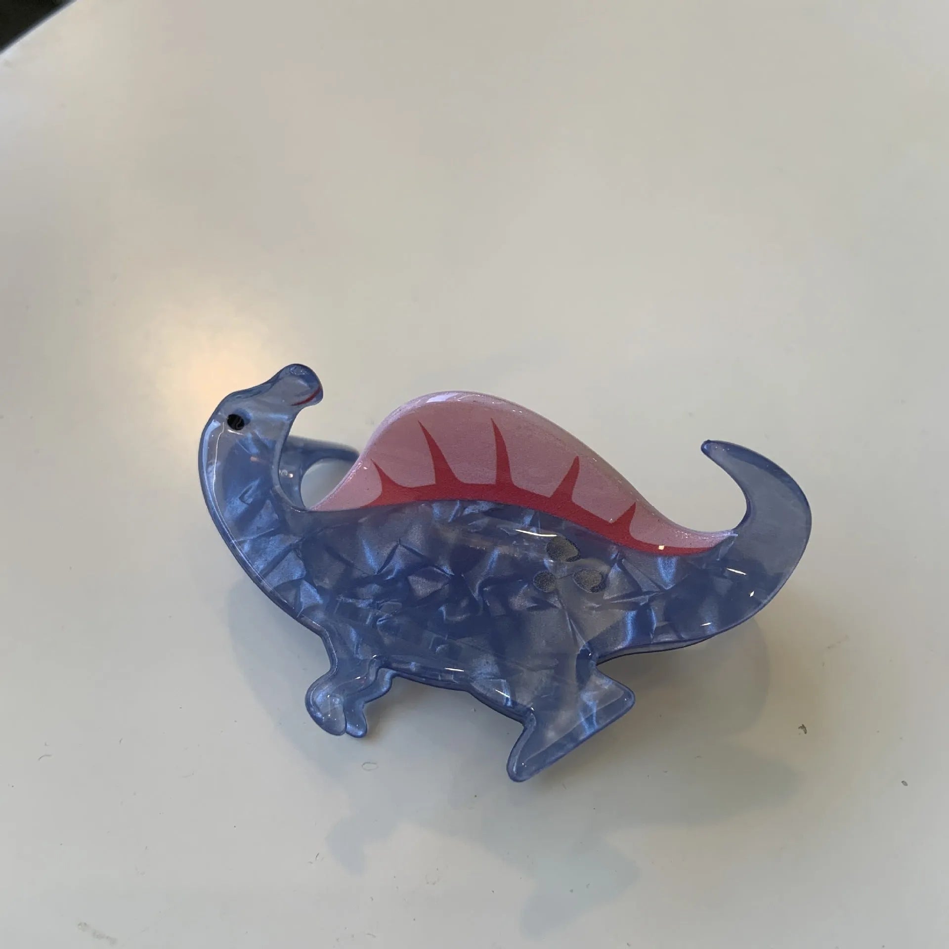 Dinosaur-themed acrylic jaw hair clip showing detailed dinosaur design and secure grip mechanism