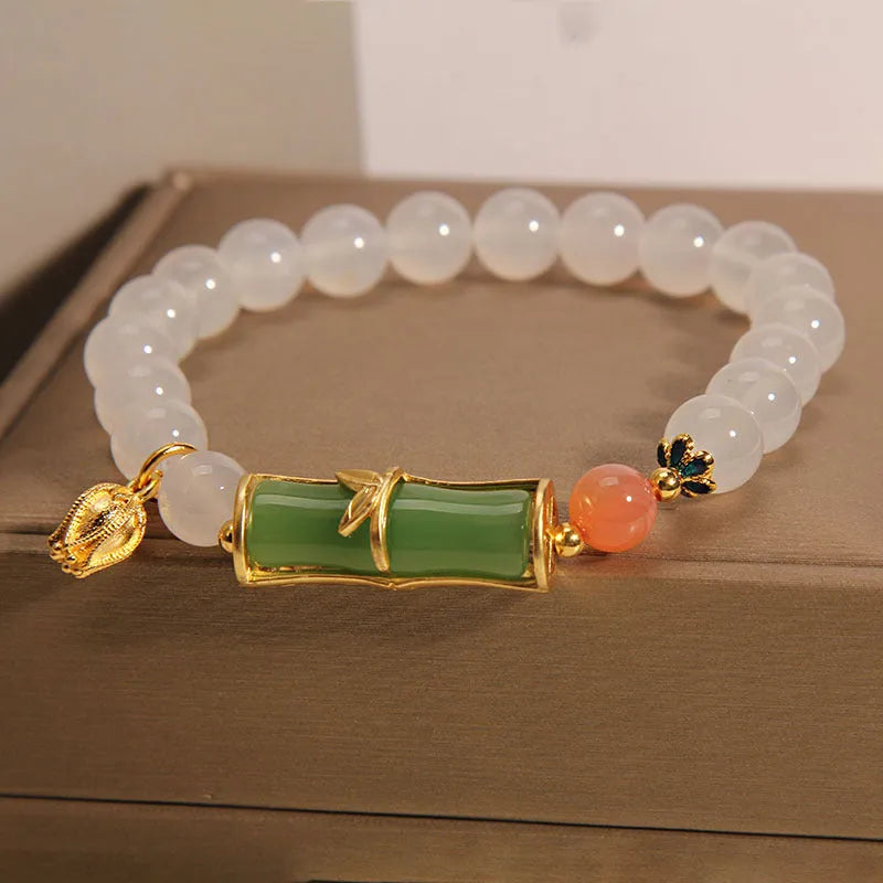White agate and jade bamboo beaded bracelet with jasper accents on a neutral background.