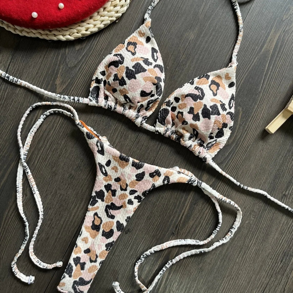 Women's briefs-style bikini swimsuit in a printed pattern, made from nylon with a cotton lining.