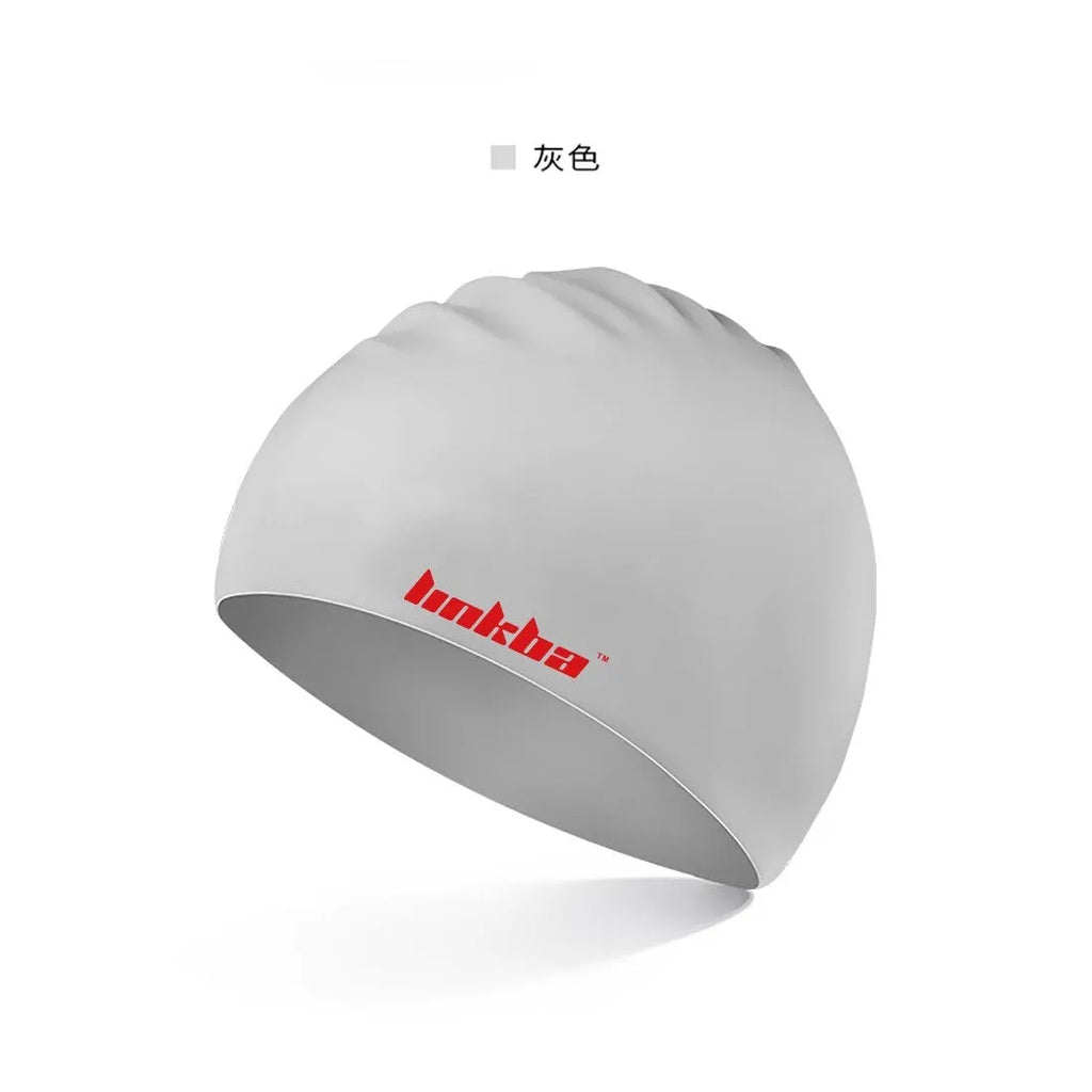 Silicone swimming cap with integrated waterproof earmuffs in multiple colours featuring a printed letter pattern.