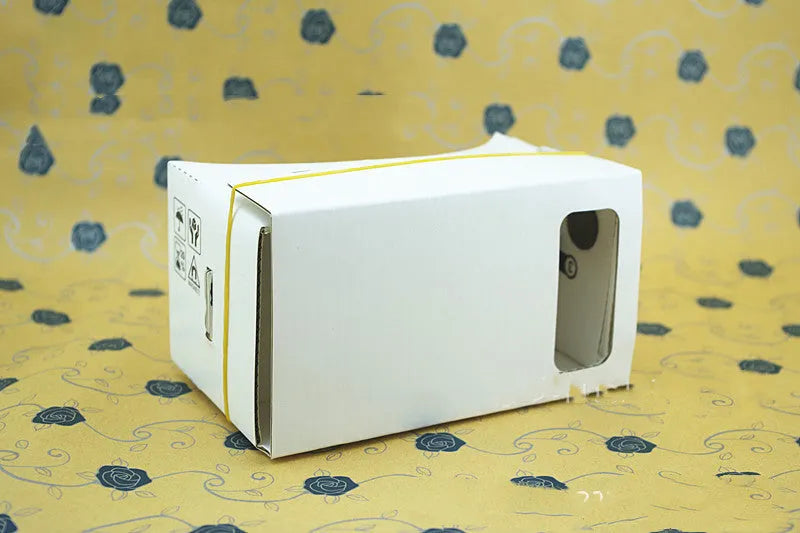 Pink and white VR cardboard glasses viewer for 6-inch smartphones with adjustable head strap.