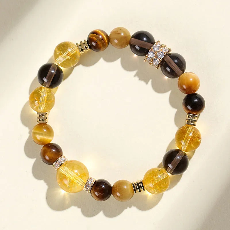 Close-up of a yellow artificial crystal beaded bracelet with 10mm Jinba beads on a wrist.