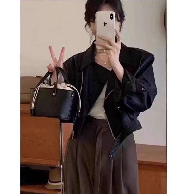 Women's slim fit imitation leather jacket in black with 40cm length and street fashion styling